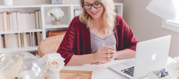 Blonde Woman With Glasses Drinking Tea With Laptop
